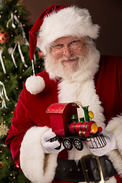 istock Real Santa Claus holding toy train 496768788