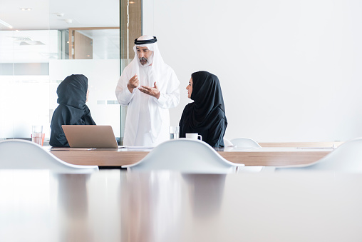 Hombre de negocios árabe y mujeres reunión en oficina moderna, Dubai photo