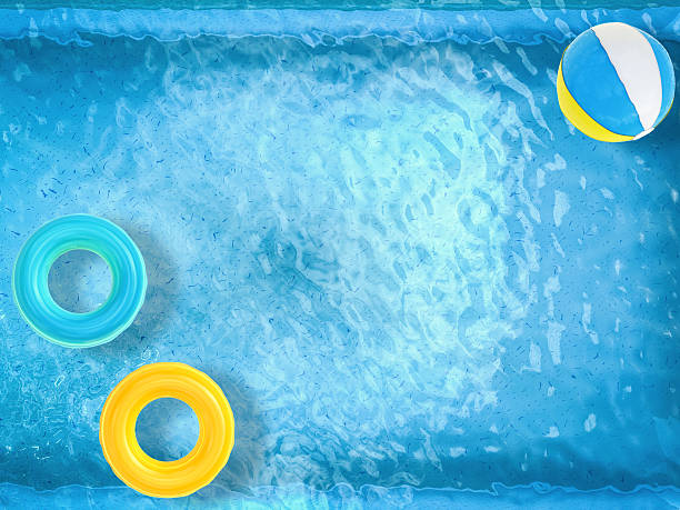 istock pool top view with swim rings and beach ball 496769620