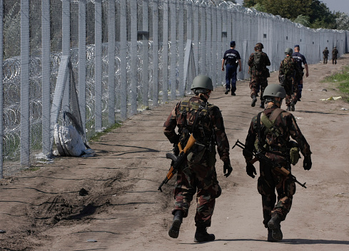 Roszke, Hungary, September 14, 2015 : Hungarian police officers and soldiers check a hole at the fence where migrants tried to cross the border line between Serbia and Hungary in Roszke, southern Hungary