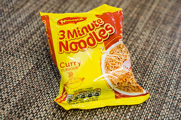 Maggi 3 minute noodles Poole, UK - November 12, 2015: A packet of cheap Maggi 3 minute noodles, curry flavour. Maggi stock pictures, royalty-free photos & images