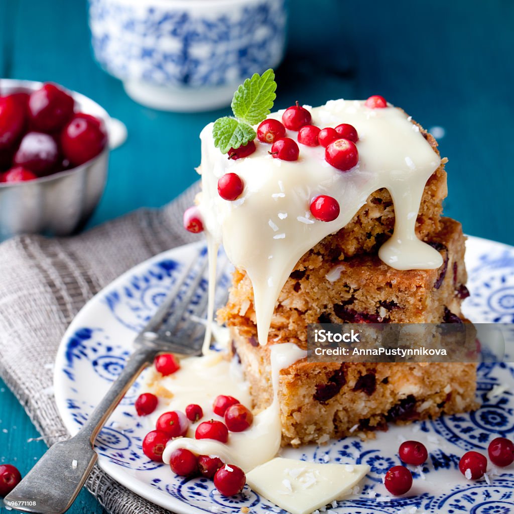 White chocolate cake, blondie, brownie with cranberry and coconut White chocolate cake, blondie, brownie with cranberry and coconut on a white and blue wooden background 2015 Stock Photo