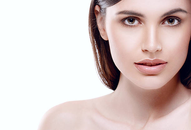 istock Beautiful woman face close up studio white sexy lips 496773406