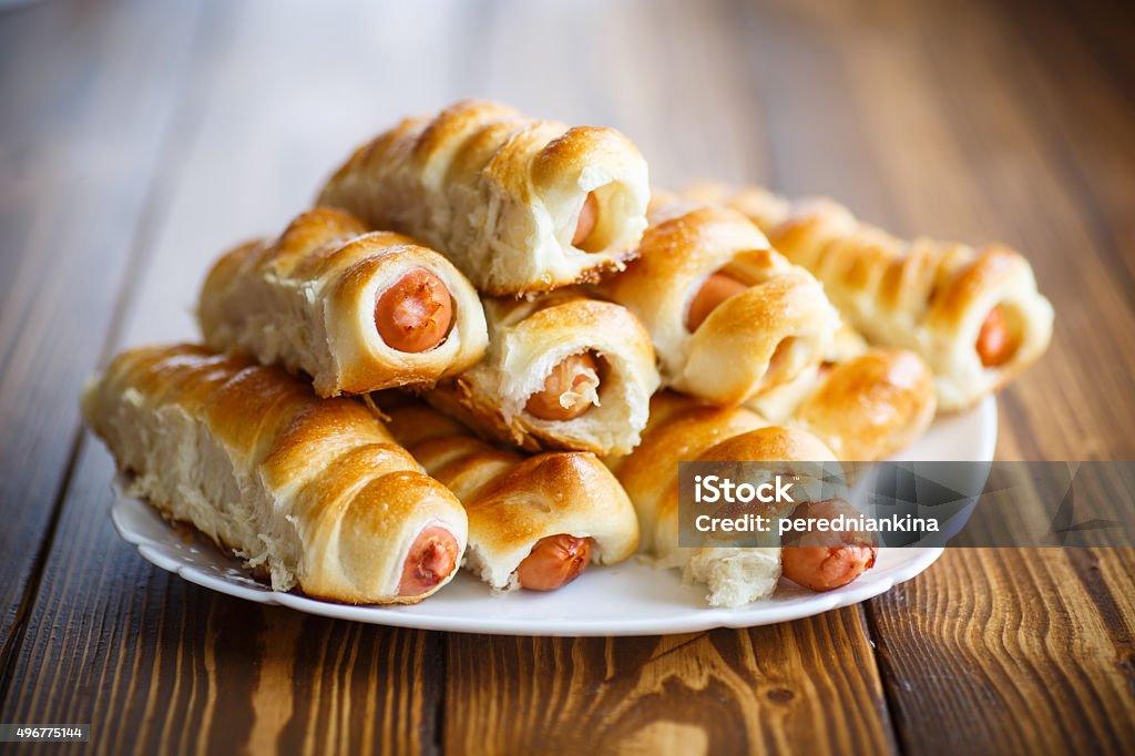 sausage baked in dough sausage baked in dough on the table 2015 Stock Photo