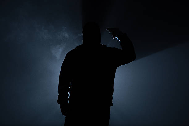 istock suicide people in the dark forest, gun in hand. 496775178