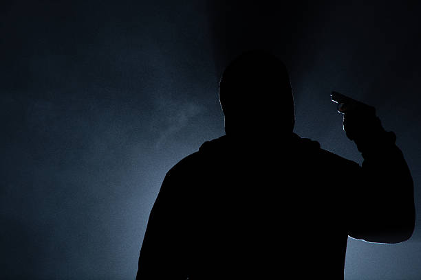 istock suicide people in the dark forest, gun in hand. 496775430