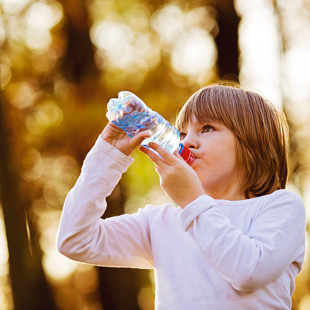 istock Thirsty Girl Drinking Water Outdoors 496775470