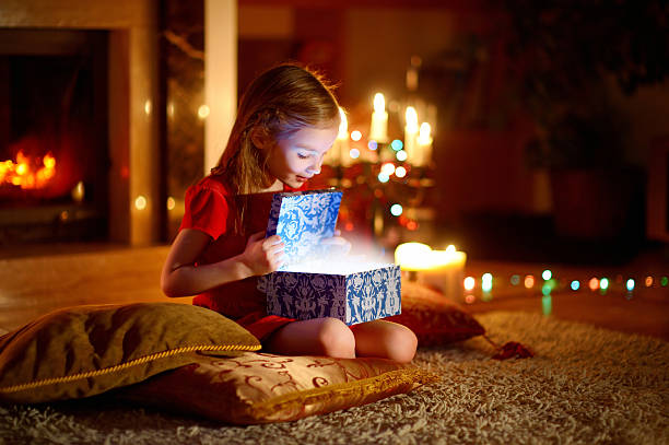 istock Little girl opening a magical Christmas gift 496775690