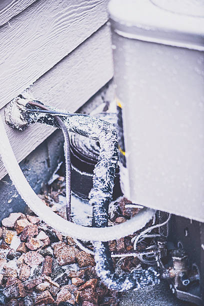 istock Frozen piping from air conditioning unit attached to home 496776268
