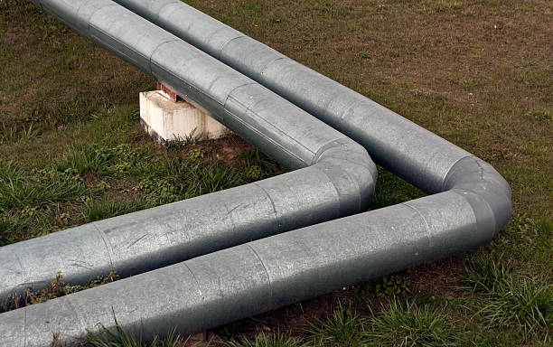 istock Steel metal tubes on grass field. 496777090