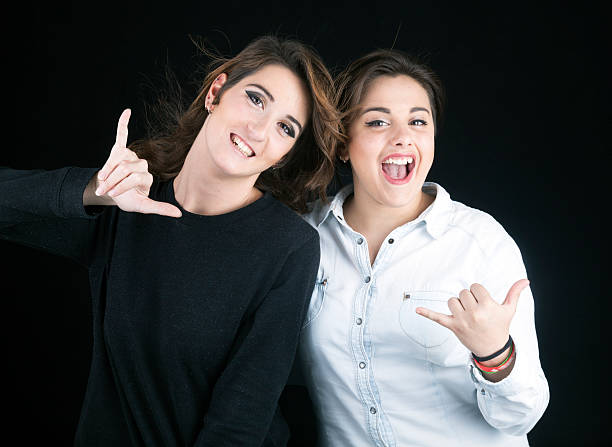 Teen girs doing the shaka sign