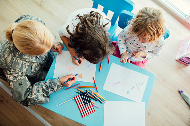 istock Military Mom Coloring With Her Kids. 496779018