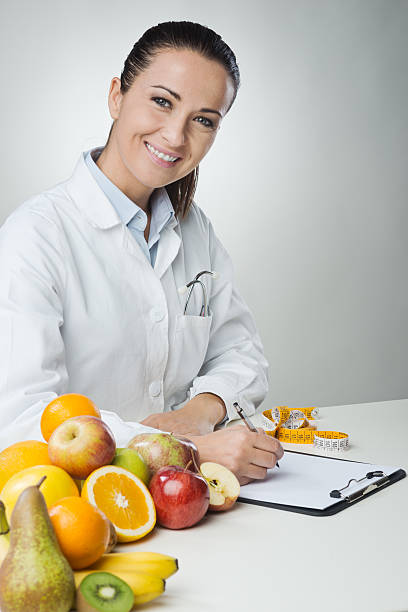 istock Smiling nutritionist writing medical records 496788606