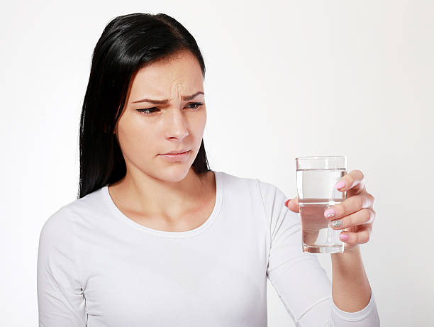 asian woman looking at water looking unhappy stock photo