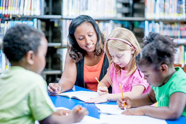 istock Teacher Helping a Little Girl 496792220