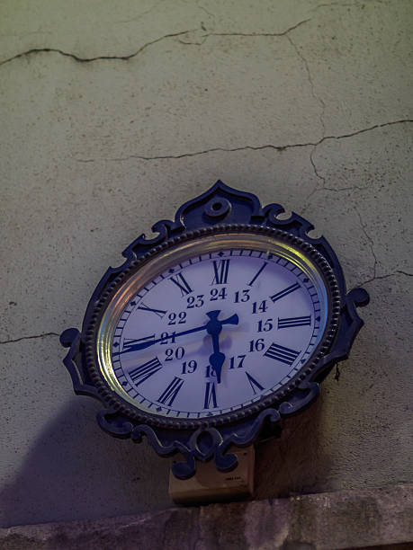 Old Clock in a street of Geneva in the evening