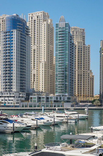 Dubai, UAE - October 2, 2015: Marina walk district in Dubai, close to Jumeirah beach. Dubai Marina is an artificial canal city, carved along 3 km stretch of Persian Gulf shoreline.