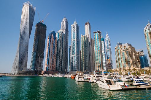 Dubai, UAE - March 28, 2015:  Modern buildings in Dubai Marina. Part of city with artificial channel length of 3 kilometers along the Persian Gulf.