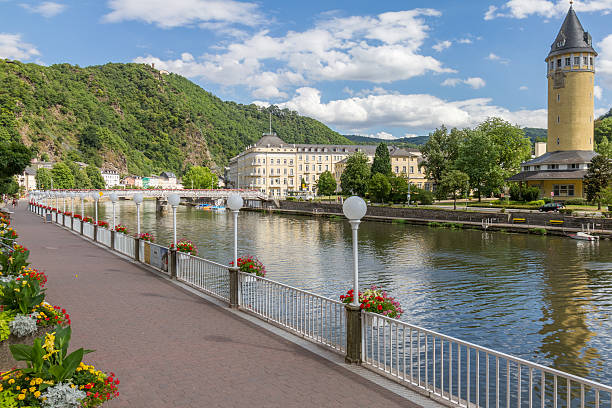 On May 17th 2025, capturing an early morning scene in Karlovy Vary, Czech Republic. Locals stroll through the quiet shopping street, surrounded by elegant architecture, boutiques, and the Castle Colonnade in the distance.