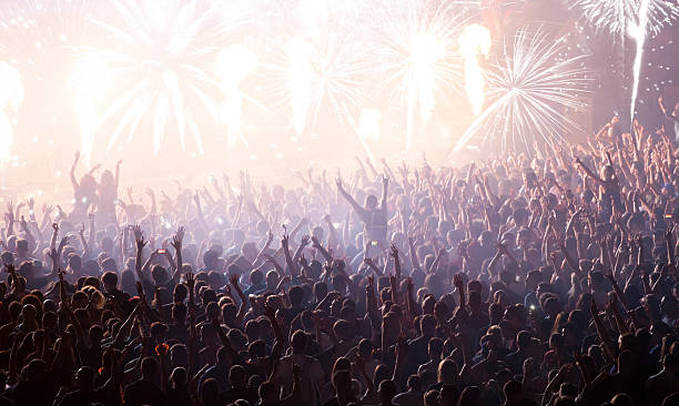 istock New Year concept - cheering crowd and fireworks 496794446