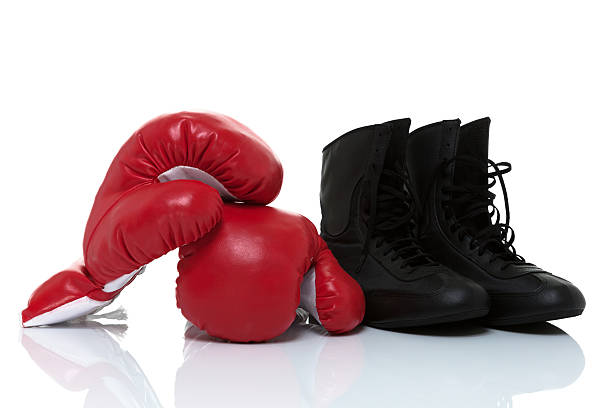 istock Red boxing gloves and shoes isolated on white 496795504