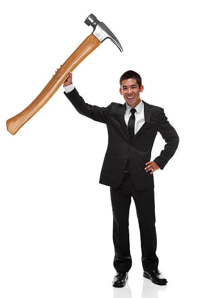 istock Businessman holding a gaint hammer up as a business tool 496795648