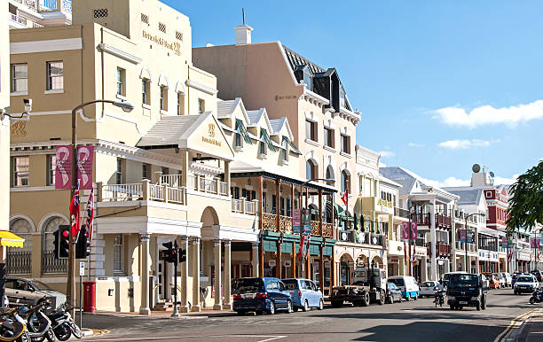 Front Street, Hamilton, Bermuda, with traffic and pedestrians. A view of Front Street in Hamilton, Bermuda, with shops and retail stores. bermuda stock pictures, royalty-free photos & images