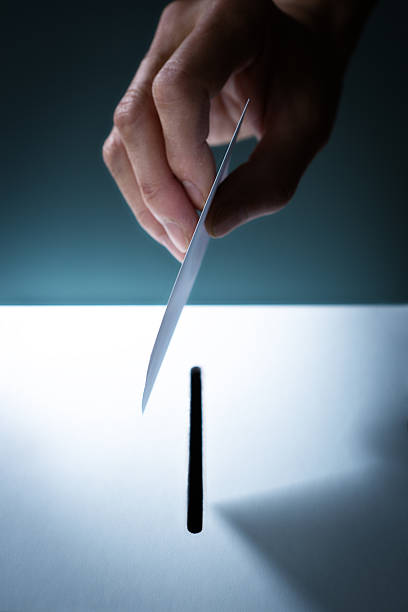 istock Hand Inserting a Voting Card into a Slot of a Ballot Box 496796292