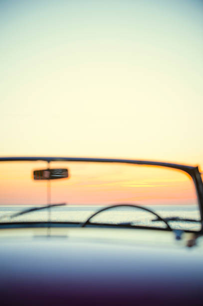 istock Convertible at the beach at sunset or sunrise. 496796468