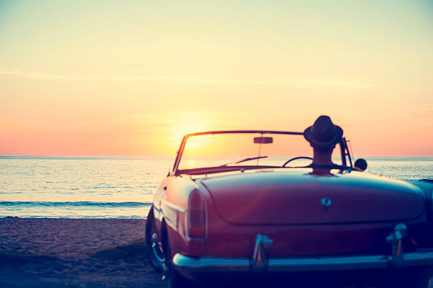 istock Mature man driving a convertible car at the beach. 496796514