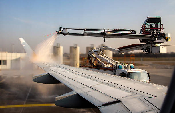 De-icing of an airplane at Munich Airport, Germany, 2015 stock photo