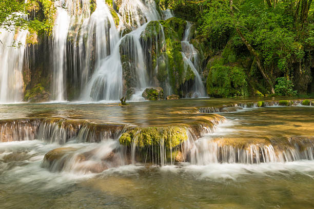 Waterfall in France Waterfall in French Jura Mountains: Cascade of Tuff (la cascade de tuf) near Arbois. - Long exposure with motion blur. jura france stock pictures, royalty-free photos & images