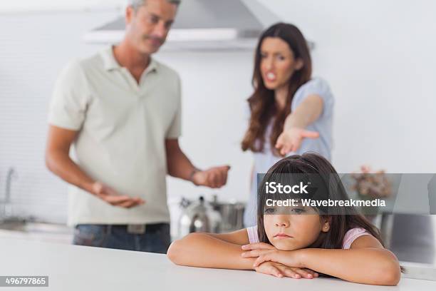 Couple Having Dispute In Front Of Their Upset Daughter Stock Photo - Download Image Now