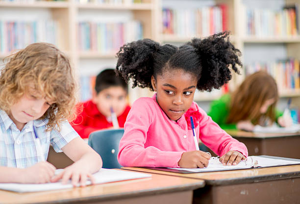 istock Little Girl Copying Answers 496797894