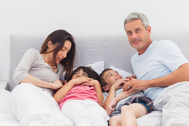 istock Cheerful family lying on bed 496798397