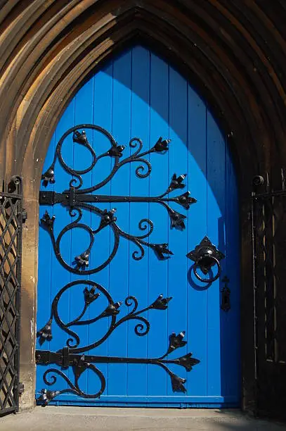 Blue church door with heavy wrought iron hinges