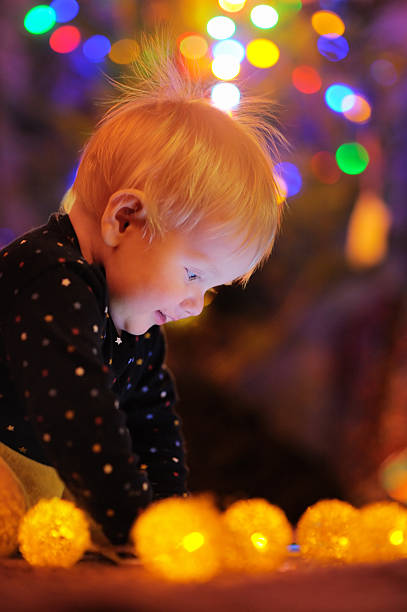 istock Little baby playing by a Christmas tree 496799670