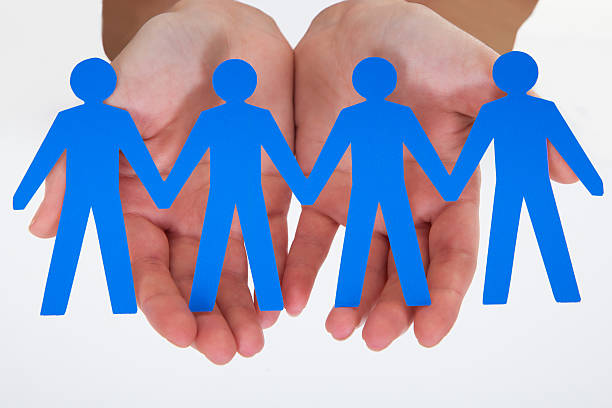 istock Male Hand Holding Human Figure Cutout 496800159