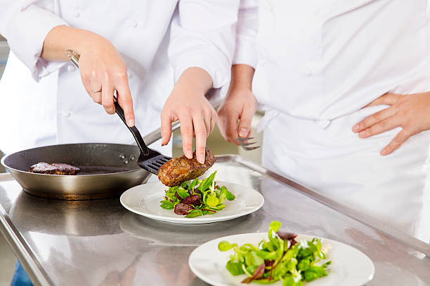 istock Professional chefs prepares steak dishes at restaurant 496801116