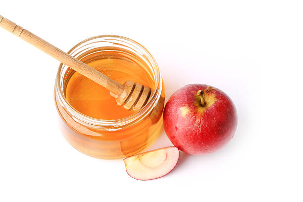 istock apple with honey isolated on a white background 496801904