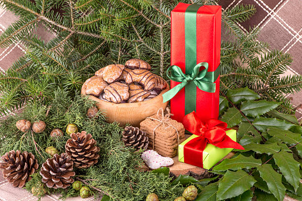 Christmas decoration with fir branches, mistletoe, wood cookies and gifts