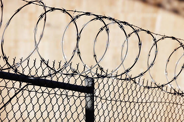 istock Razor Wire Barbed Fence Barrier 496802608
