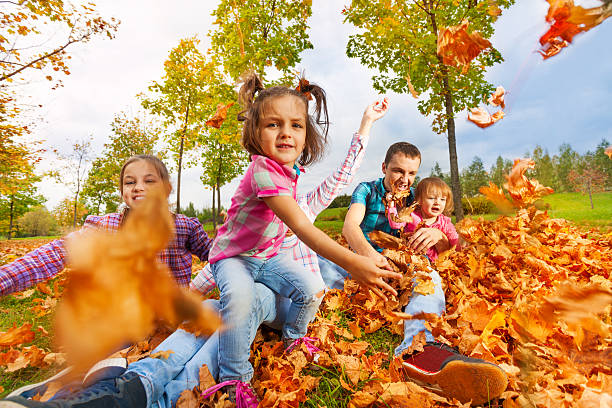 istock Girl throws autumn maple leaves to camera 496802870