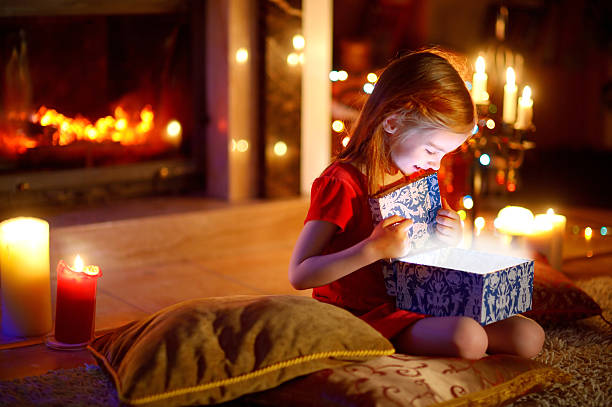 istock Little girl opening a magical Christmas gift 496803694