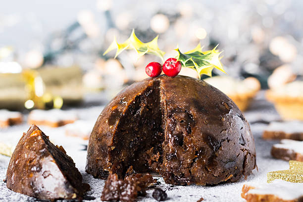 Christmas Pudding, mince pies and Cookies Christmas Pudding, mince pies and Christmas cookies. Christmas scene and decorations in the background. christmas pudding stock pictures, royalty-free photos & images