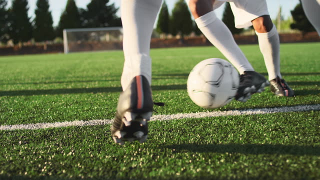 A soccer player does some fancy footwork while going up against other players