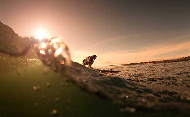 istock The girl with surf at sunrise 496814403