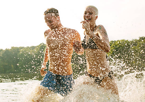 istock Good friends running into the lake 496814783