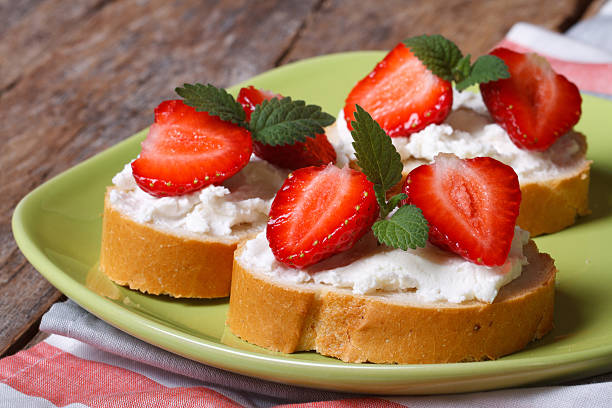 istock Sandwiches with fresh strawberries, mint and cream cheese 496815971