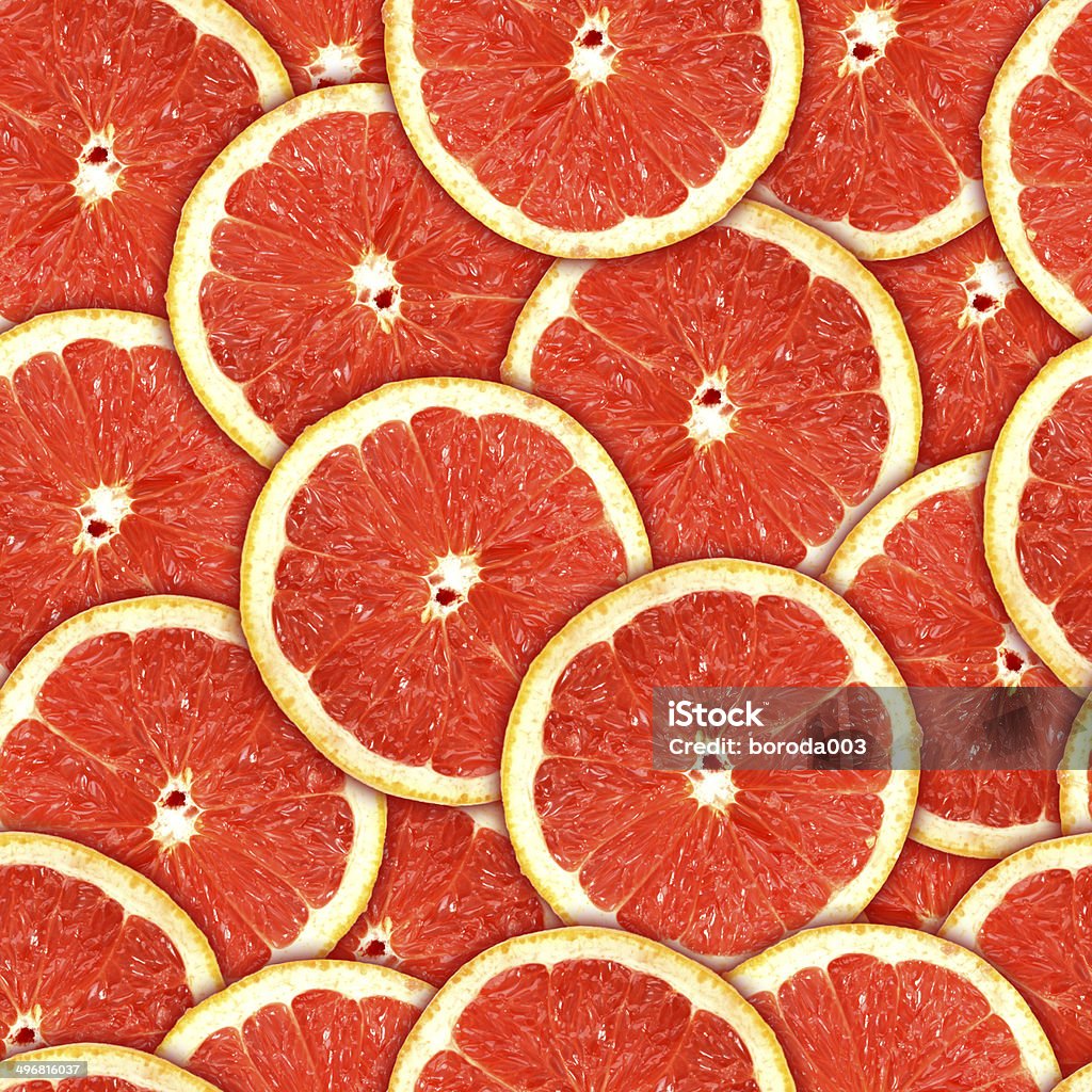 Seamless pattern of red grapefruit slices Abstract background of heap fresh red grapefruit slices. Seamless pattern for your design. Close-up. Studio photography. Grapefruit Stock Photo